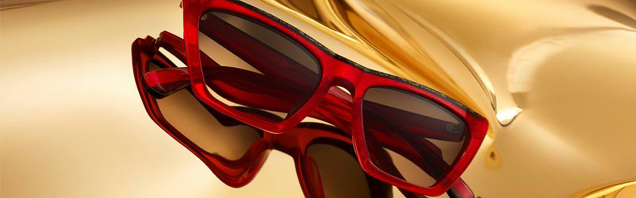 red sunglasses on a gold colored background