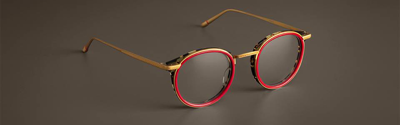 eyeglass frames with red frames and gold colored trim